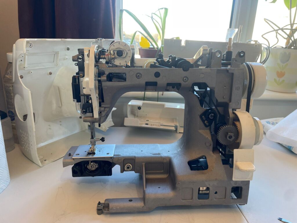a stripped sewing machine ready for a service in calne