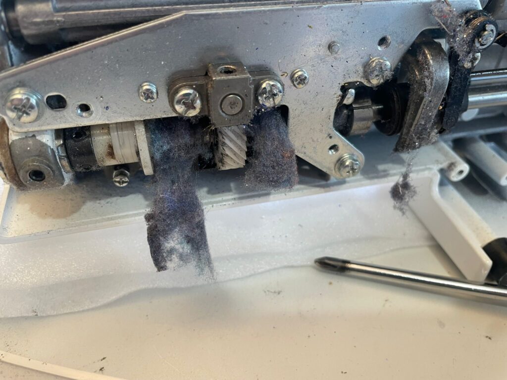 Sewing machine full of lint needing a deep clean service